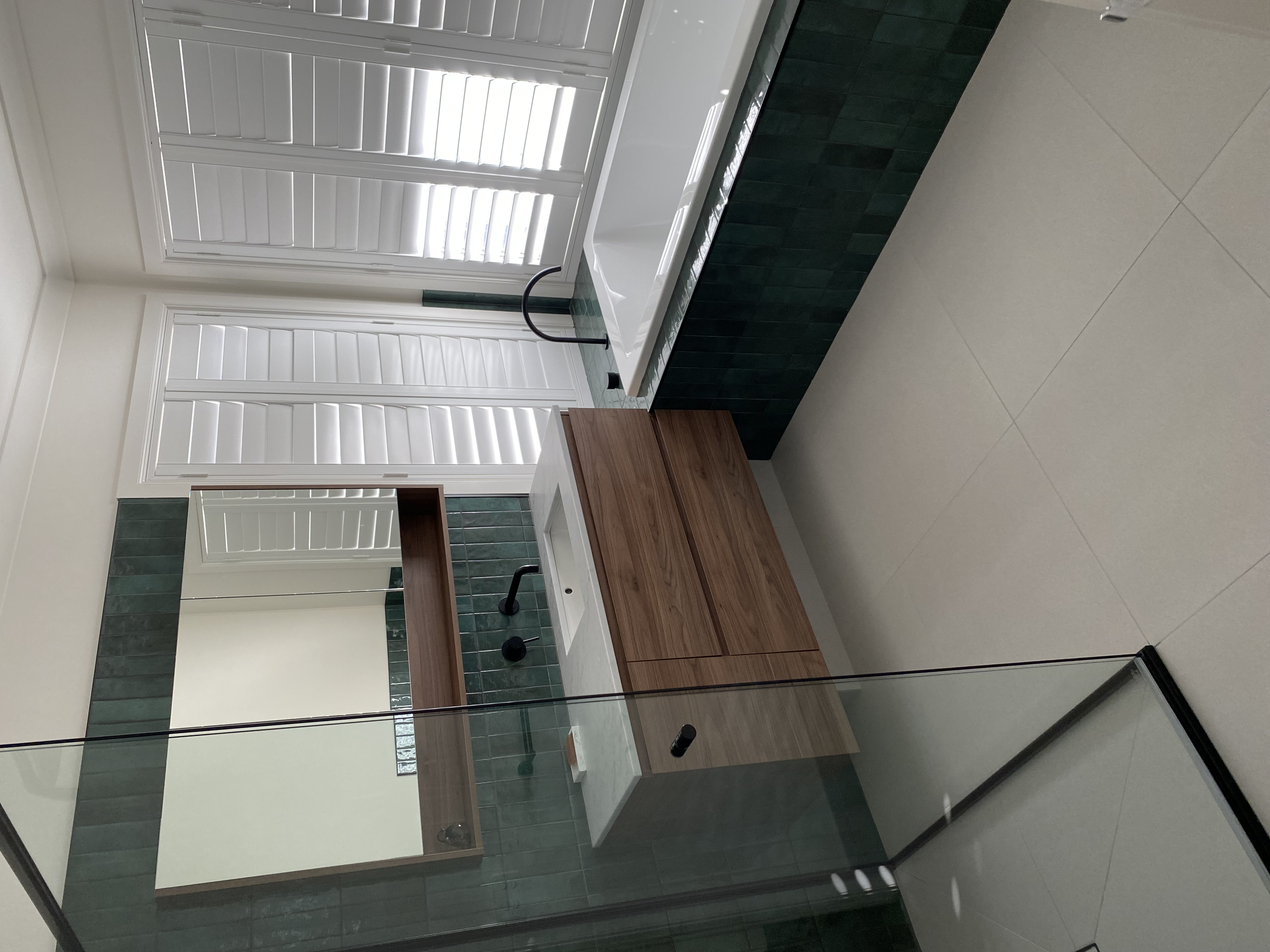 Plantation shutters provide privacy for a bath time soak