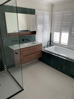 Plantation shutters provide privacy for a bath time soak